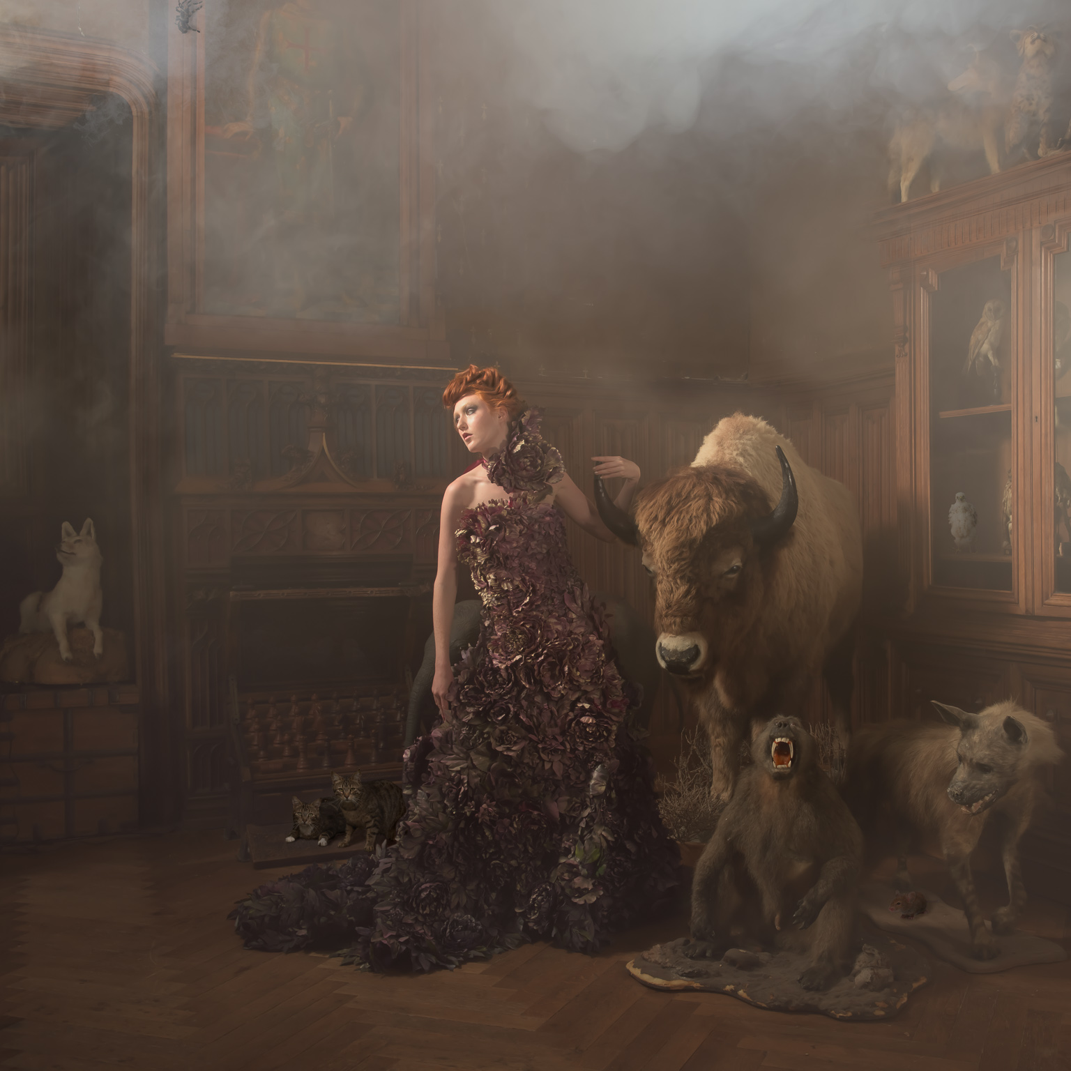 conceptual fashion in French chateau with middle Kim Davis wearing designer dress with stuffed animals. taken by Ian Mears